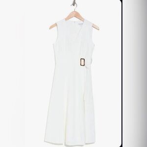 White Calvin Klein gold belted a-line dress.